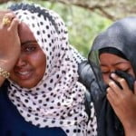 epa03405488 Sahra Isse (L) and Sa'diyo mourn the death of their brother Abdi Satar, as hundreds take part in the funeral 21 September 2012 of victims killed in a suicide bomb attack in Mogadishu, Somalia 20 September 2012. According to Somali police officials two suicide bombers killed 14 including three journalists and wounded more. The attacks happened at Village restaurant near the National Theater.  EPA/ELYAS AHMED