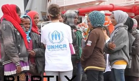 A demonstrator kicks a tear gas canister back to the riot police during an anti-government protest in Ankara