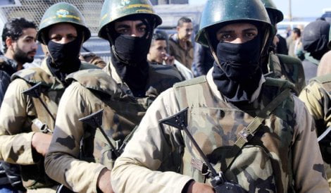 Army soldiers take position to stop clashes between supporters and opponents of ousted Egyptian President Mohamed Mursi around the main university in Alexandria