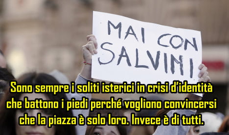 A woman holds a placard reading "Never with Salvini" during a protest against a rally held by Northern League party leader Matteo Salvini in downtown Rome